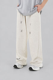 Jogging Y2K édition 'Star Burst Beige', vue de face, sur fond studio gris clair.