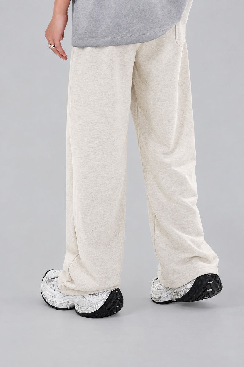 Jogging Y2K édition 'Star Burst Beige', vue de dos, sur fond studio gris clair.